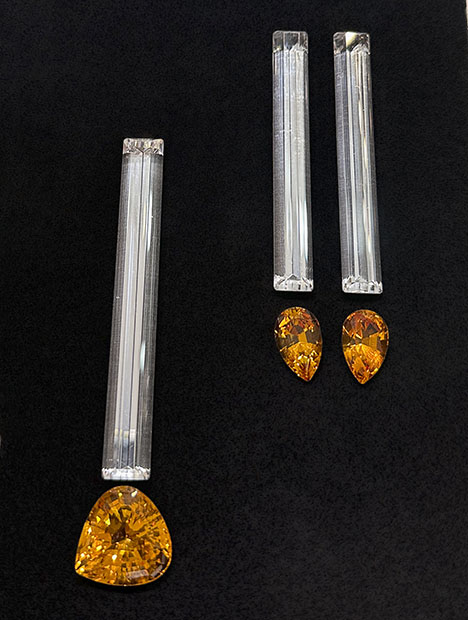 Figure 11. Elongated baguette-cut rock quartz from Brazil (left, 80 × 10 mm, 61.41 ct stone; right, two 70 × 9 mm stones totaling 83.07 carats) accented by Bolivian citrine (left, 25.27 ct triangular brilliant; right, two pear brilliants totaling 15.30 carats). Photo by Jennifer Stone-Sundberg; courtesy of Pillar & Stone International. Figure 11. Elongated baguette-cut rock quartz from Brazil (left, 80 × 10 mm, 61.41 ct stone; right, two 70 × 9 mm stones totaling 83.07 carats) accented by Bolivian citrine (left, 25.27 ct triangular brilliant; right, two pear brilliants totaling 15.30 carats). Photo by Jennifer Stone-Sundberg; courtesy of Pillar & Stone International.