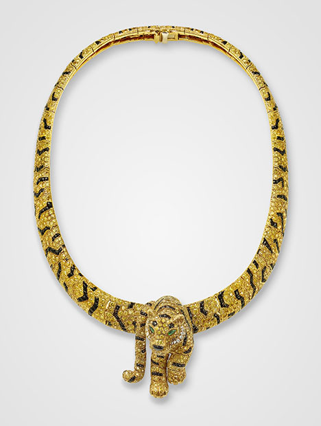 Figure 6. Tiger necklace and detachable brooch, Cartier Paris, 1986. Intensely colored yellow diamonds, marquise-shaped emeralds (eyes), and onyx (stripes) set in gold, showing Cartier’s patented “fur setting” developed in the 1980s. Courtesy of the Cartier collection. Figure 6. Tiger necklace and detachable brooch, Cartier Paris, 1986. Intensely colored yellow diamonds, marquise-shaped emeralds (eyes), and onyx (stripes) set in gold, showing Cartier’s patented “fur setting” developed in the 1980s. Courtesy of the Cartier collection.