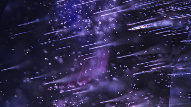 Numerous Rose channels with scattered zircon crystal inclusions in a 3.46 ct color-change sapphire. Photomicrograph by Michaela Damba; field of view 4.79 mm. Numerous Rose channels with scattered zircon crystal inclusions in a 3.46 ct color-change sapphire. Photomicrograph by Michaela Damba; field of view 4.79 mm.