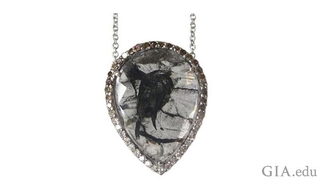 A 4.10 ct colorless diamond “slice” pendant with black inclusions set in white gold and surrounded by colorless to brown pavé diamonds by Rachel Boston, London. Photo courtesy Rachel Boston A 4.10 ct colorless diamond “slice” pendant with black inclusions set in white gold and surrounded by colorless to brown pavé diamonds by Rachel Boston, London. Photo courtesy Rachel Boston