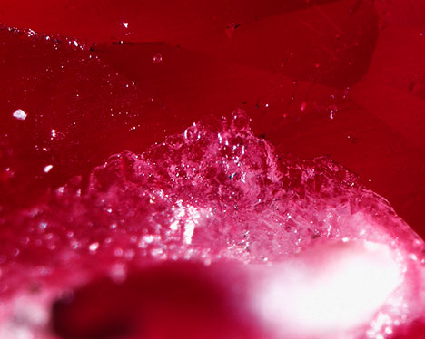 Synthetic overgrowth on heated Burmese ruby. Synthetic overgrowth on heated Burmese ruby.