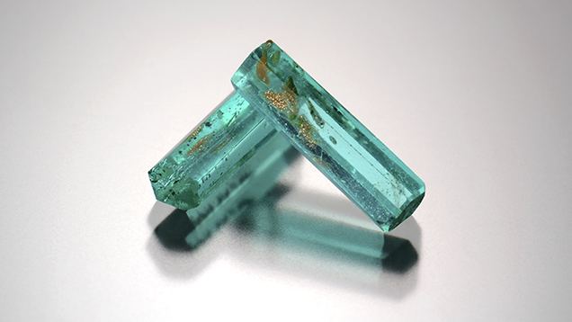 Two glass prisms imitate Paraíba tourmaline crystals. Two glass prisms imitate Paraíba tourmaline crystals.