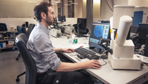 Evan Smith studies images of diamond inclusions on a computer.