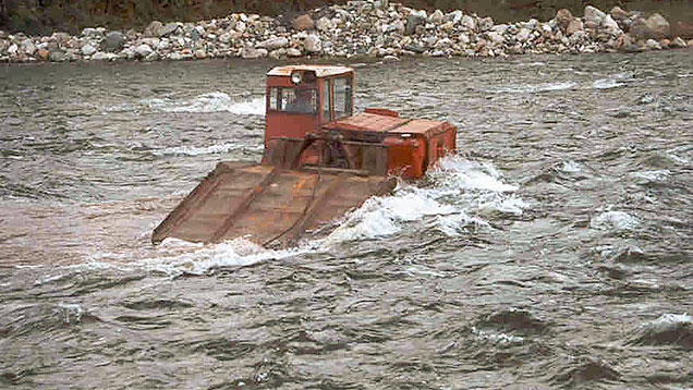 Tractor and equipment crossing a river