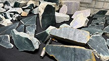 Figure 1. The rough Guatemalan jadeite jade sold by Yax Tun Minerals included blue, green, and lavender hues, with blue being the most prevalent. Photo by Tao Hsu; courtesy of Yax Tun Minerals.