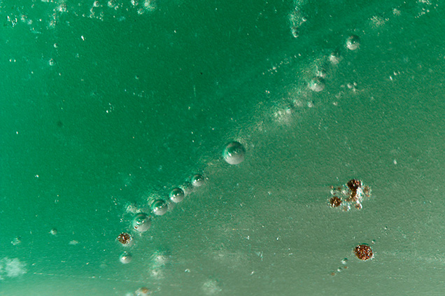 Gas bubbles of various sizes were observed in the purplish gray and green bangle. Gas bubbles of various sizes were observed in the purplish gray and green bangle.