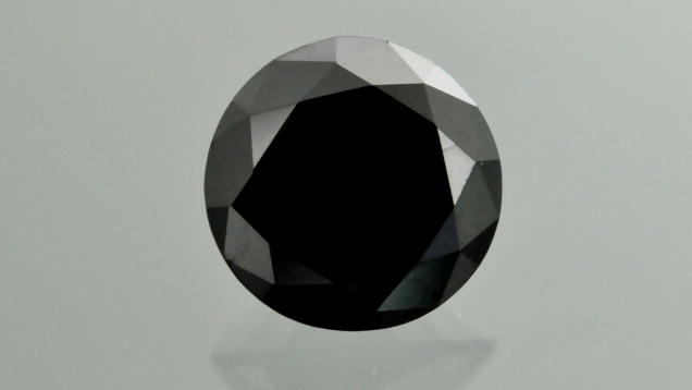 This 1.04 ct black submetallic round brilliant, initially represented as diamond, was identified as boron carbide. Photo by G. Choudhary.