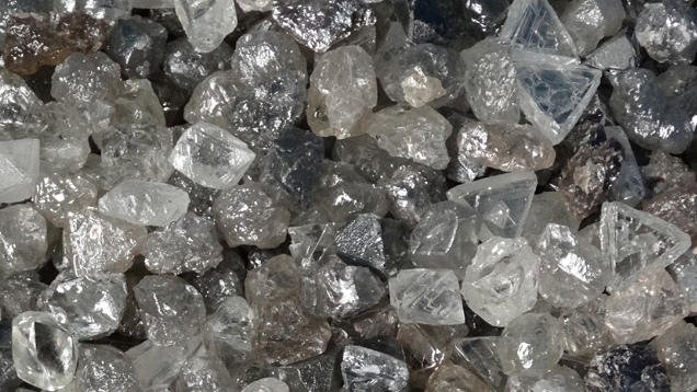A close-up image of a pile of rough diamonds. A close-up image of a pile of rough diamonds.