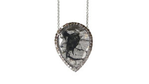 A 4.10 ct colorless diamond “slice” pendant with black inclusions set in white gold and surrounded by colorless to brown pavé diamonds by Rachel Boston, London. Photo courtesy Rachel Boston