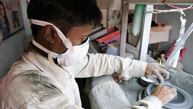 Gem cutters in Jaipur wear masks provided by AGTA. Gem cutters in Jaipur wear masks provided by AGTA.