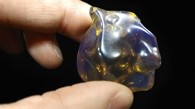 Artificial glass resembling blue amber. Artificial glass resembling blue amber.