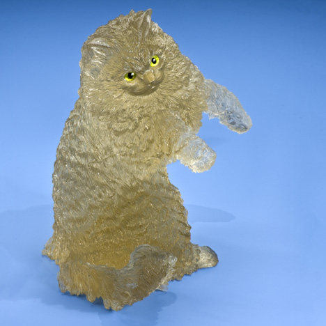 This golden cat is carved in citrine from Brazil. Its eyes are made of peridot and gold. - Robert Weldon This golden cat is carved in citrine from Brazil. Its eyes are made of peridot and gold. - Robert Weldon