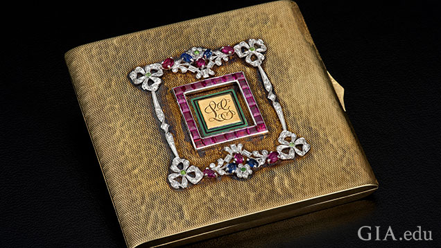 Square, gold compact embellished with garnets and diamonds. 