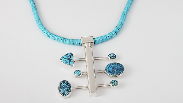 Figure 3. Nebula series necklace by Sam Patania, featuring sterling silver and spiderweb turquoise from the Number 8 mine in Nevada used for the pendant, while the necklace consists of turquoise beads from the Sleeping Beauty mine in Arizona. Photo by Sam Patania; courtesy of Patania Jewelry. Figure 3. Nebula series necklace by Sam Patania, featuring sterling silver and spiderweb turquoise from the Number 8 mine in Nevada used for the pendant, while the necklace consists of turquoise beads from the Sleeping Beauty mine in Arizona. Photo by Sam Patania; courtesy of Patania Jewelry.