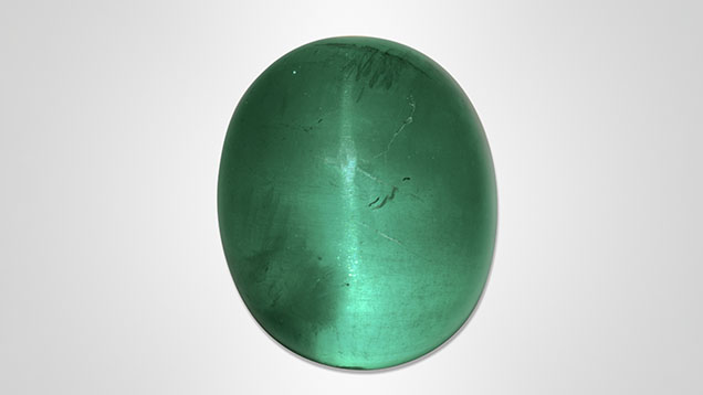 Figure 1. An unusually large cat’s-eye emerald weighing approximately 126 ct. Photo by Shunsuke Nagai. Figure 1. An unusually large cat’s-eye emerald weighing approximately 126 ct. Photo by Shunsuke Nagai.