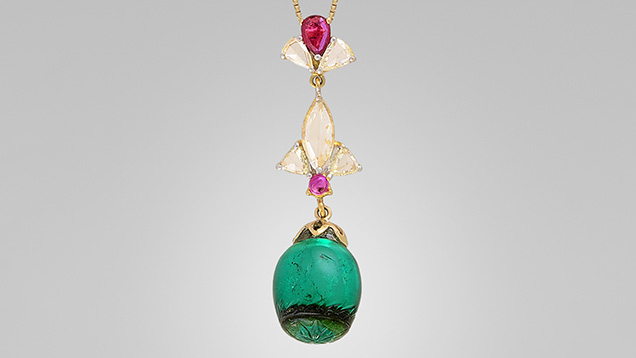 Figure 1. A pendant necklace featuring a green stone measuring 13.35 × 12.20 × 12.20 mm that was identified as a quartz assemblage. Photo by Michele Wong. Figure 1. A pendant necklace featuring a green stone measuring 13.35 × 12.20 × 12.20 mm that was identified as a quartz assemblage. Photo by Michele Wong.