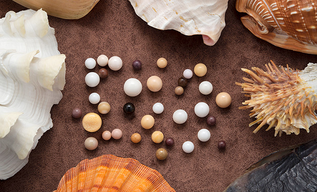 Figure 1. A set of 35 non-nacreous pearls submitted for examination exhibited a variety of colors and surface structures, indicating they were formed by various mollusk species. Photo by Nuttapol Kitdee.