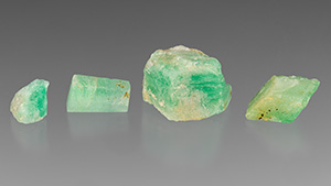 Figure 1. Emerald and beryl specimens from Newfoundland, Canada. The chip on the right has a distinct green rim in this position, on its lower right edge. Photo by Emily Lane; courtesy of Art Gardner and Terry Russell.