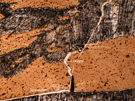 Thin section of sample showing serpentine, calcite, and quartz veins Thin section of sample showing serpentine, calcite, and quartz veins