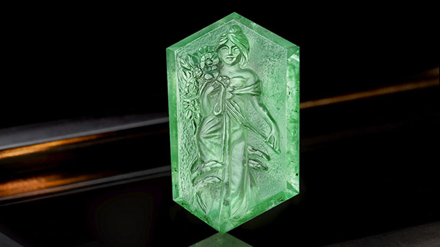 Figure 1. A Russian emerald carving, approximately 41 × 25 mm, of a woman holding blooming flowers, reportedly fashioned by Michael Peuster. Photo by Ronnakorn Manorotkul; courtesy of Tsarina Jewels. Figure 1. A Russian emerald carving, approximately 41 × 25 mm, of a woman holding blooming flowers, reportedly fashioned by Michael Peuster. Photo by Ronnakorn Manorotkul; courtesy of Tsarina Jewels.