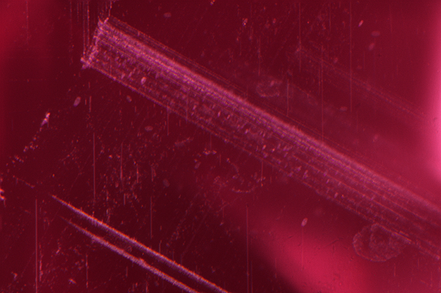Dense bands of exsolution rutile in Montana sapphire. Dense bands of exsolution rutile in Montana sapphire.
