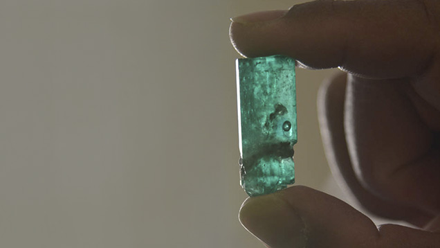Emerald crystal with multi-phase inclusion Emerald crystal with multi-phase inclusion