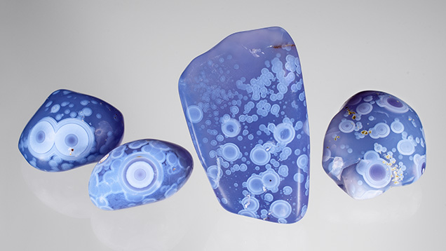 Figure 1. This relatively new type of violet chalcedony from Ethiopia (here, 75–198 ct) displays a wonderful pattern of white orbs. Photo by Annie Haynes; courtesy of Orbit Ethiopia Plc. Figure 1. This relatively new type of violet chalcedony from Ethiopia (here, 75–198 ct) displays a wonderful pattern of white orbs. Photo by Annie Haynes; courtesy of Orbit Ethiopia Plc.