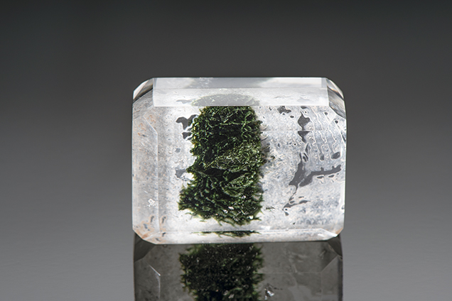Assembled block of polished quartz encloses fractures filled with a green resin. Assembled block of polished quartz encloses fractures filled with a green resin.