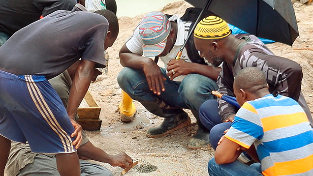Figure 2. Miners sorting through gem gravel. Courtesy of Diamonds for Peace. Figure 2. Miners sorting through gem gravel. Courtesy of Diamonds for Peace.