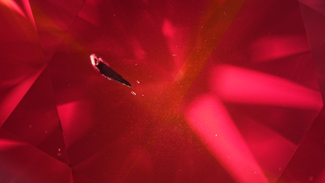 Large metallic inclusion in Fancy Red HPHT synthetic diamond Large metallic inclusion in Fancy Red HPHT synthetic diamond