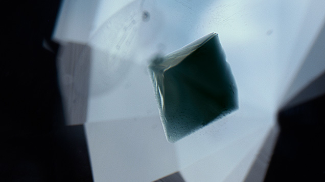 A greenish blue octahedral crystal of gahnospinel found in Sri Lankan blue sapphire. Photomicrograph by Yusuke Takamura; field of view 3.81 mm. A greenish blue octahedral crystal of gahnospinel found in Sri Lankan blue sapphire. Photomicrograph by Yusuke Takamura; field of view 3.81 mm.