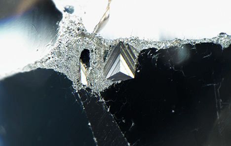 The original crystal surface seen as a trigon.