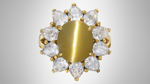 Figure 1. A ring mounted with an estimated 5.56 ct brownish yellow cat’s-eye cabochon resembling chrysoberyl. Photo by Johnny (Chak Wan) Leung. Figure 1. A ring mounted with an estimated 5.56 ct brownish yellow cat’s-eye cabochon resembling chrysoberyl. Photo by Johnny (Chak Wan) Leung.