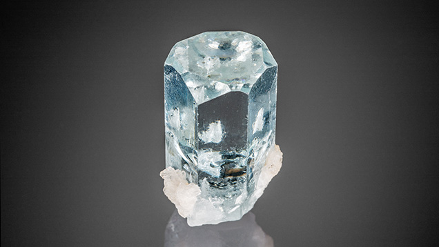 Hexagonal growth hillocks decorate the termination of this Pakistani aquamarine. Hexagonal growth hillocks decorate the termination of this Pakistani aquamarine.