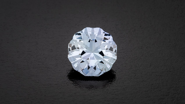 Figure 3. A 4.44 ct grayish violetish blue modified round brilliant Montana sapphire, precision cut by Joyce Wang to maximize light return. Photo by Robert Weldon; courtesy of Obsessed Over Gems.