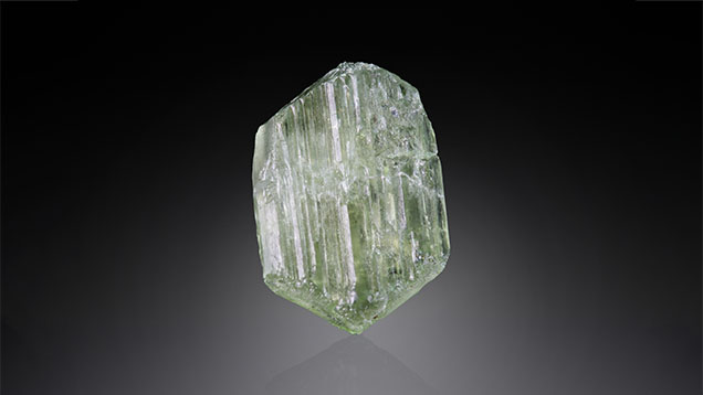 Figure 3. This 2.30 ct doubly terminated hiddenite crystal comes from the Adams mine in North Carolina, the first known locality for the gem. Photo by Annie Haynes.
