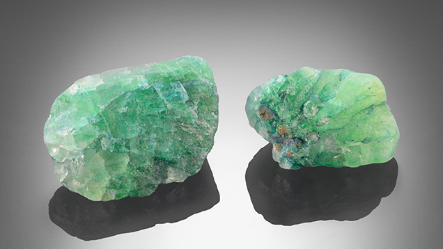 Two rough pieces of dyed fluorite.
