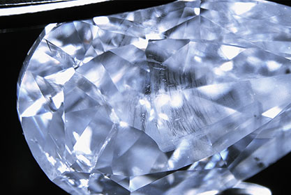 Figure 4. Fine milky cloud inclusions are responsible for the natural blue color of the type IIa diamond, shown in darkfield illumination. Photo by Paul Johnson.