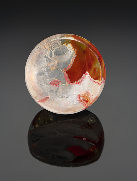 Orange and yellow resin fills fractures in this round quartz tablet. Orange and yellow resin fills fractures in this round quartz tablet.