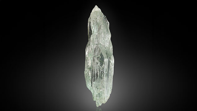 Figure 1. Weighing 20.57 ct and measuring 37.10 mm in length, this doubly terminated, heavily etched spodumene crystal contains chromium as its coloring agent or chromophore. Photo by Adriana Robinson.