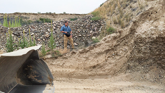 Man next to mining pit Man next to mining pit