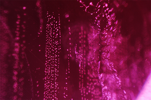 Linear stringers of flux particles within natural corundum. Linear stringers of flux particles within natural corundum.