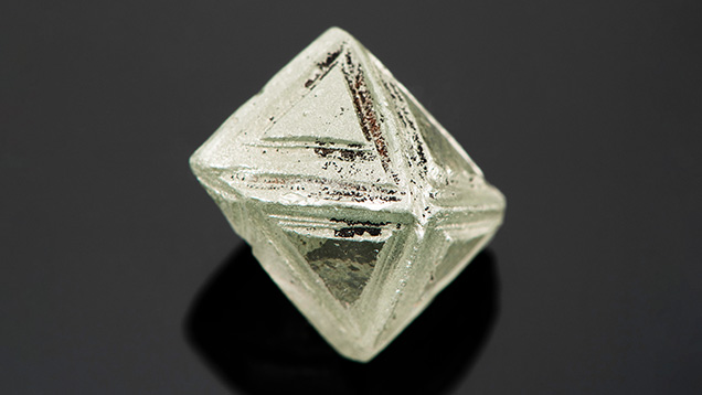Synthetic moissanite crystal carved to resemble a natural diamond rough. Synthetic moissanite crystal carved to resemble a natural diamond rough.