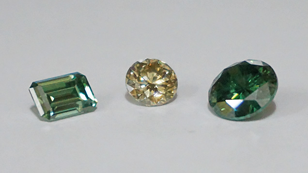 Synthetic moissanite imitating synthetic colored diamonds.