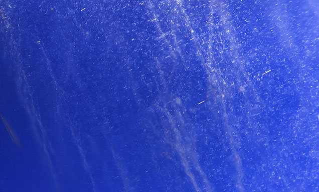 Exsolution silk seen amid particle stringers in a Kashmir star sapphire. Exsolution silk seen amid particle stringers in a Kashmir star sapphire.