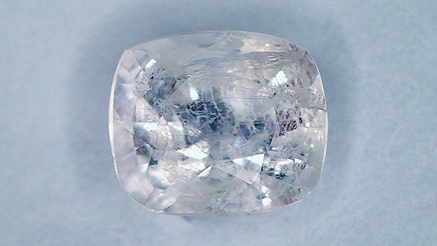 Figure 1. This 0.20 ct faceted transparent, colorless poudretteite measures 3.48 × 4.06 mm. Photo by Jianxing Wang.