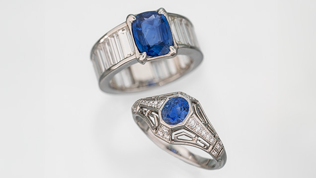 Figure 2. Two untreated Kashmir sapphire rings. Top: 1.59 ct cushion-cut cornflower blue sapphire set in white gold with VVS baguette diamonds. Bottom: 1.00 ct oval-cut medium lighter blue sapphire set in an Art Deco style diamond platinum ring. Photo by Robert Weldon; courtesy of Eddie Cleveland of KashmirBlue and Jeffery Bergman of EighthDimensionGems.