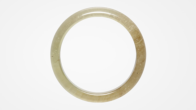 Figure 1. A 144.67 ct Libyan Desert glass bangle measuring 66.12 × 13.10 mm. Photo by Johnny Leung. Figure 1. A 144.67 ct Libyan Desert glass bangle measuring 66.12 × 13.10 mm. Photo by Johnny Leung.