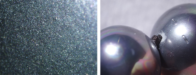 Shell pearls show glittery coating, damage near drill hole