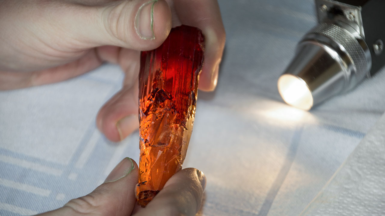 199067-1280x720.jpg. As a final prerequisite for cutting, Alexander carefully examines the crystal for any other flaws and inclusions that need to be removed by grinding. Photo courtesy Sonja Kreis Unique Jewelry.